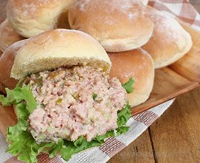 Ham salad with cheese takeaway sandwich on white bread in plastic